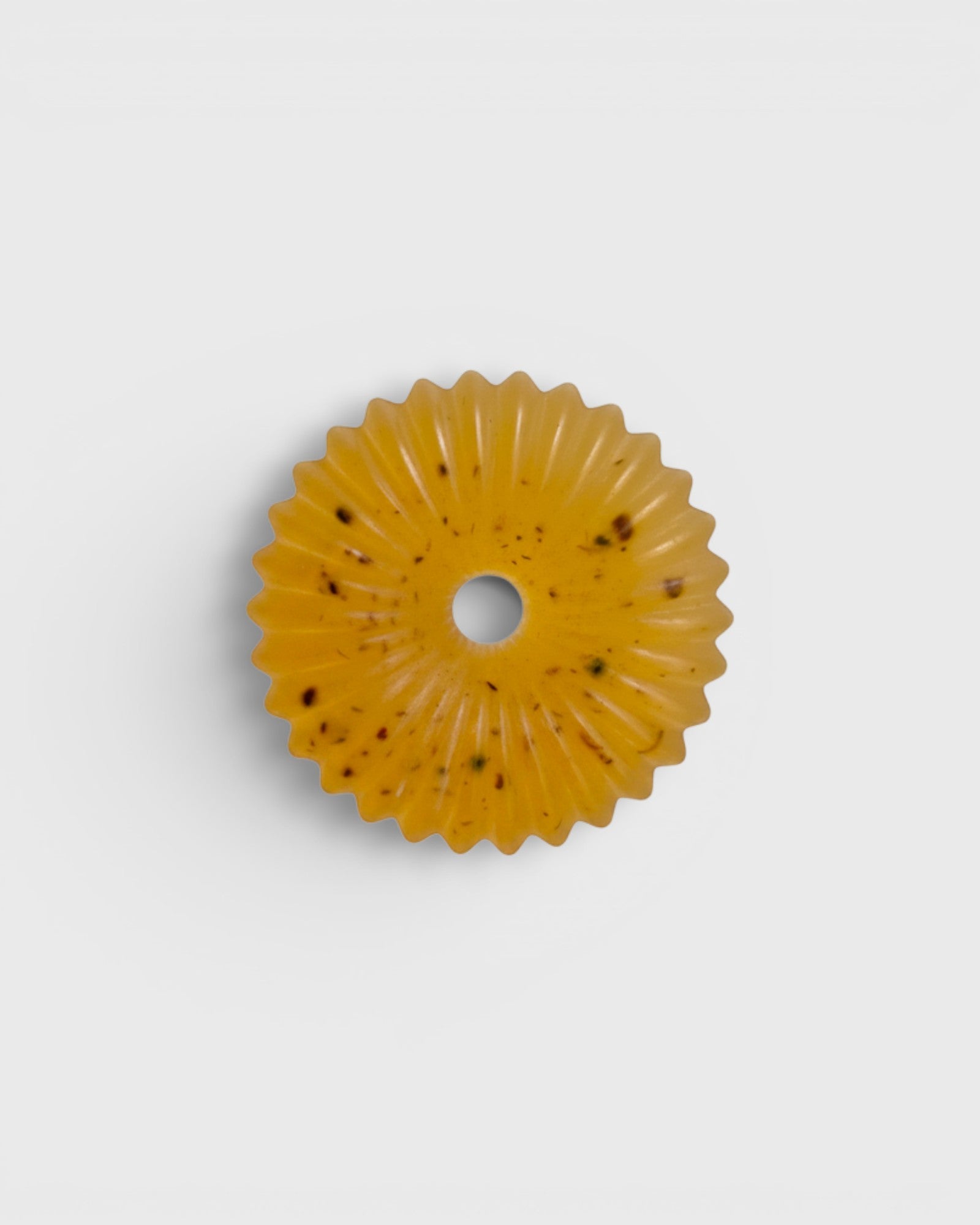 JONES + CO lülala basil and mandarin soap bar with calendula petals in a circular scalloped shape on a white background