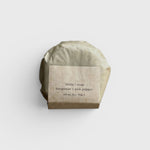 JONES + CO lülala Bergamot + Pink Pepper soap bar wrapped in sustainable brown paper packaging.