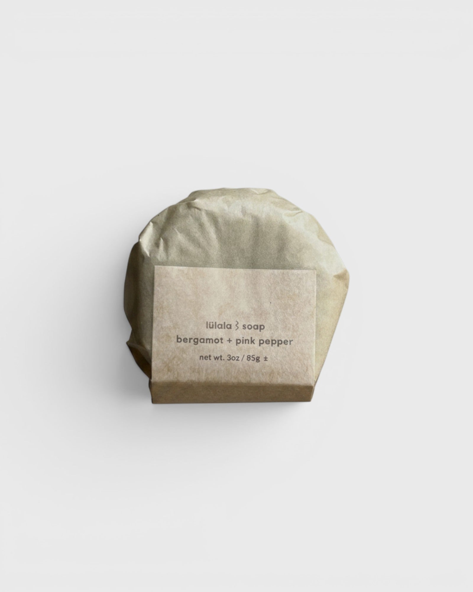 JONES + CO lülala Bergamot + Pink Pepper soap bar wrapped in sustainable brown paper packaging.