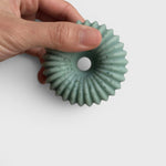JONES + CO lülala bergamot and pink pepper soap bar in a unique, ridged circular shape with a soft blue-green hue.