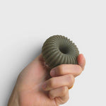 JONES + CO lülala lavender and pink grapefruit soap bar with barley, featuring a green ribbed ring shape in hand.