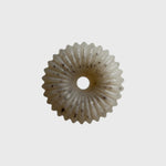 JONES + CO lülala marjoram and sesame soap bar with a unique circular, fluted design and natural black sesame specks.