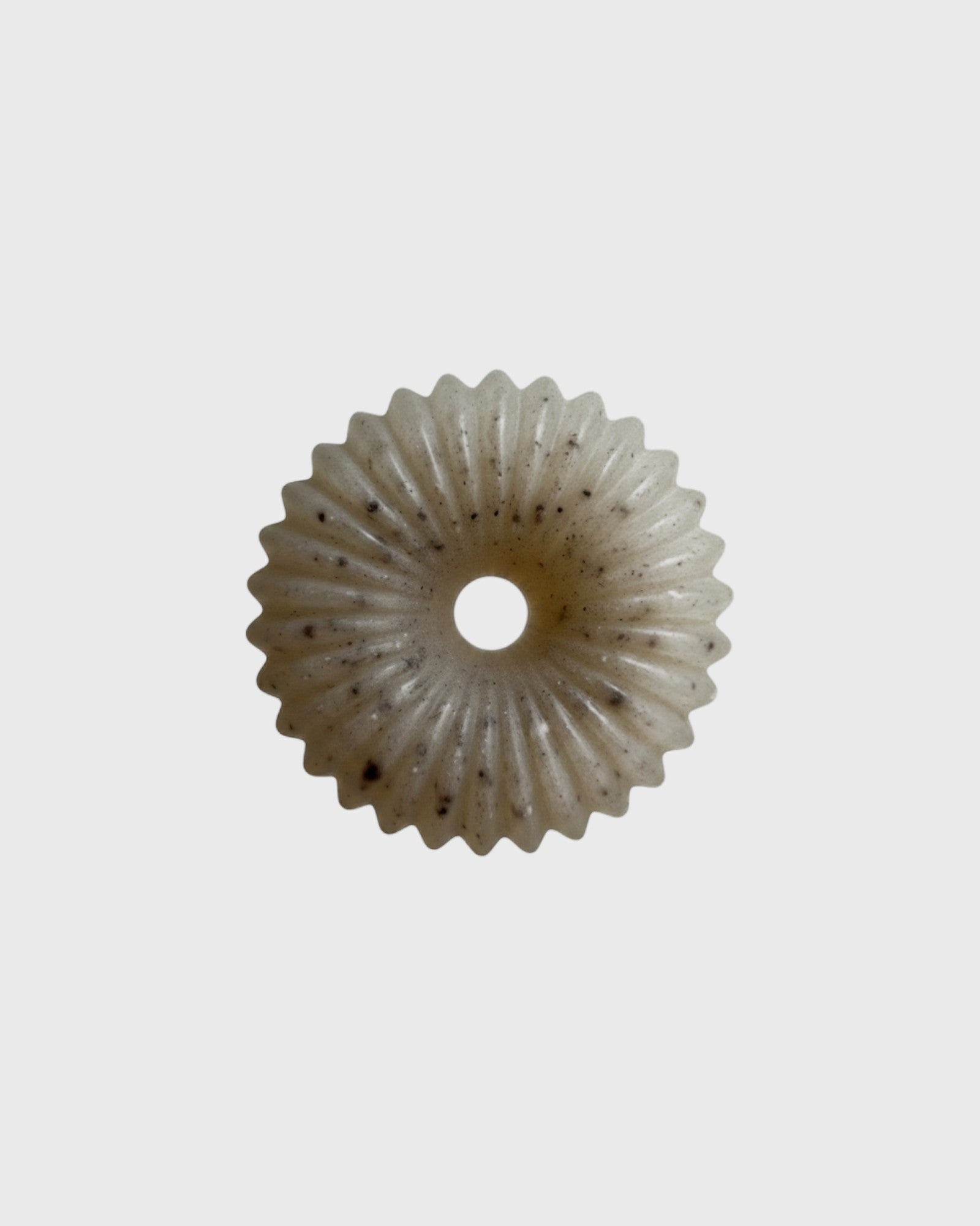 JONES + CO lülala marjoram and sesame soap bar with a unique circular, fluted design and natural black sesame specks.