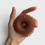 JONES + CO lülala gardenia and frankincense soap bar in a hand, featuring a pink clay fluted ring design.