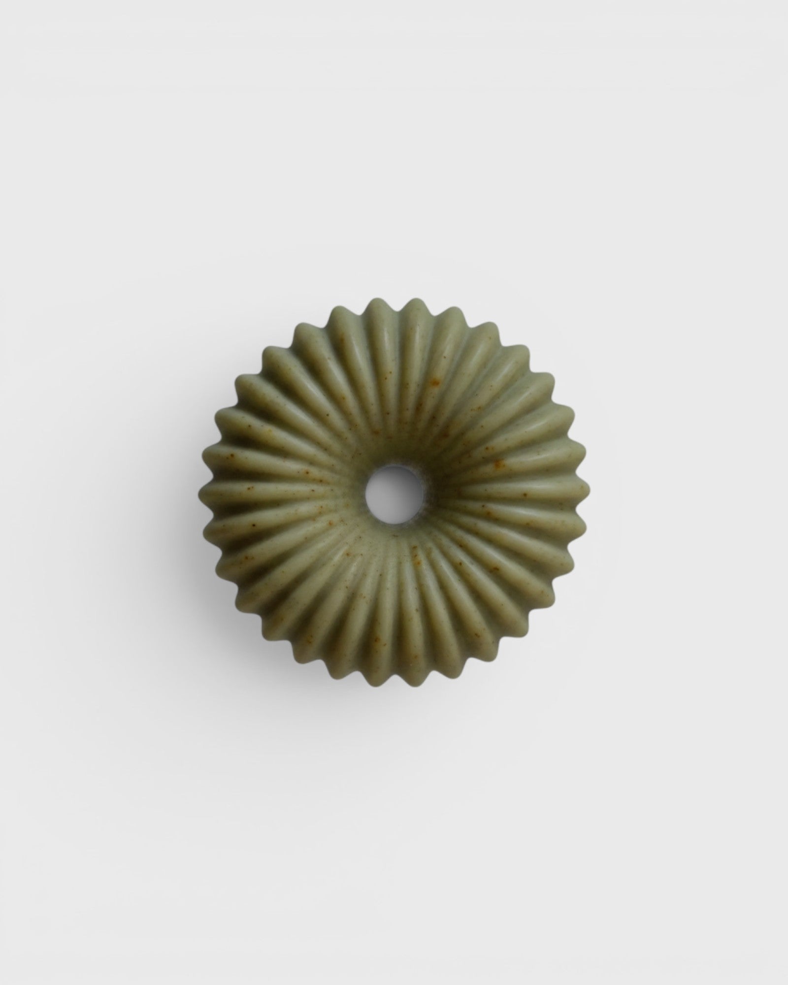 JONES + CO lülala soap bar in a sage green, fluted donut shape with organic texture and a central hole.