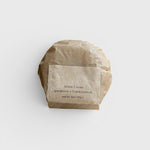 JONES + CO lülala gardenia and frankincense soap bar wrapped in sustainable brown paper packaging.