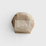 JONES + CO lülala gardenia and frankincense soap bar wrapped in sustainable brown paper packaging.