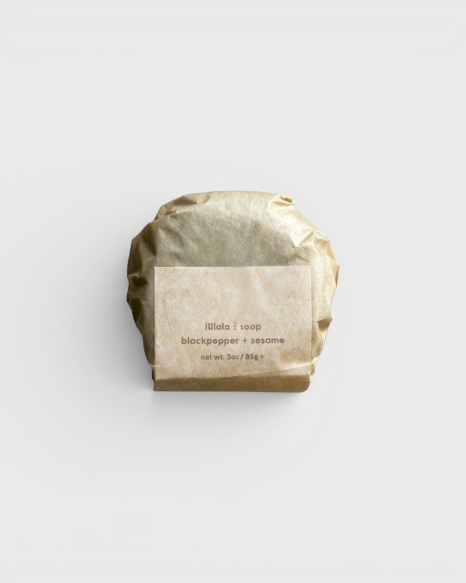 JONES + CO lülala black pepper and sesame soap bar wrapped in minimalist brown paper packaging