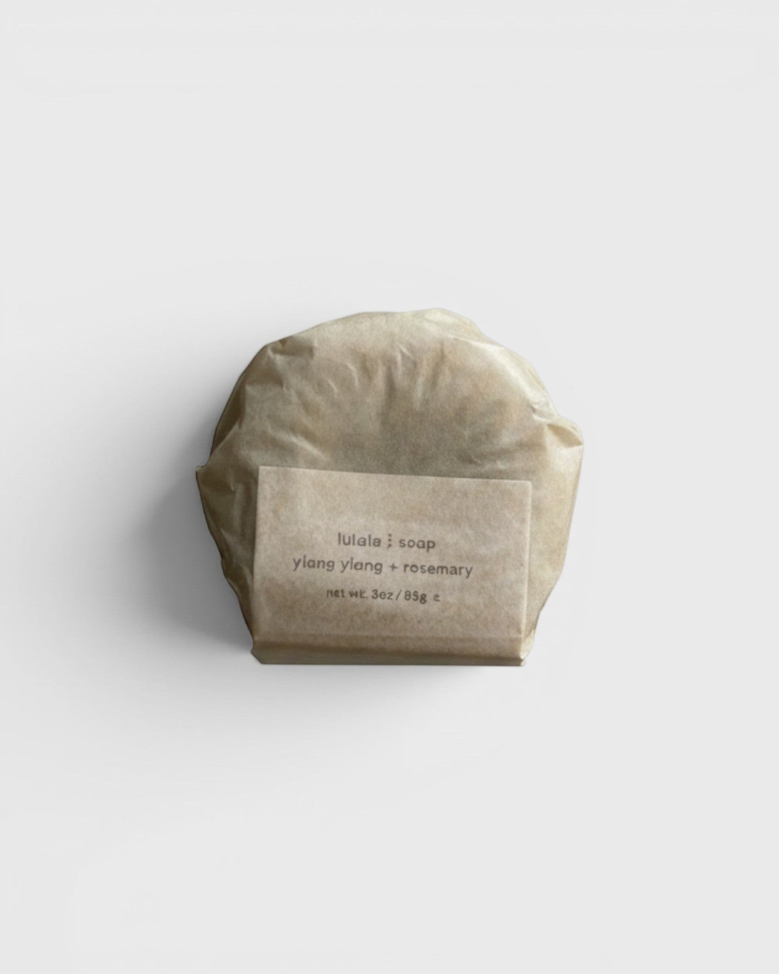 JONES + CO lülala ylang ylang and rosemary soap bar wrapped in minimalist brown paper packaging.