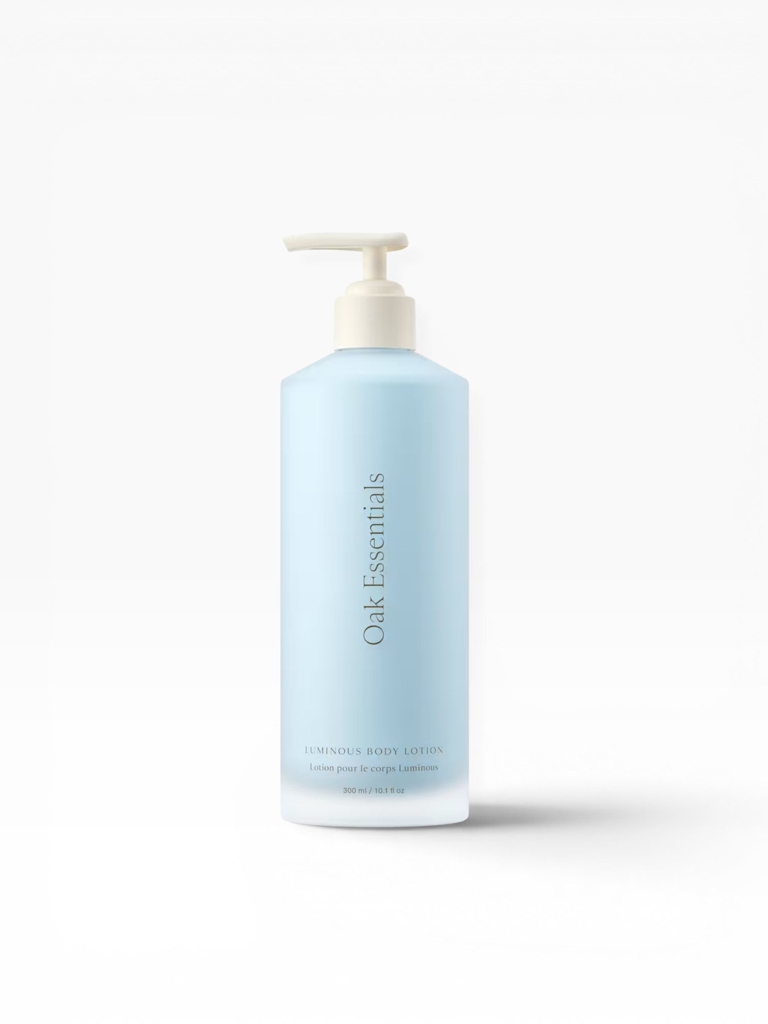 JONES + CO Luminous Body Lotion in a pale blue pump bottle with Oak Essentials branding. Contains Blue Tansy.