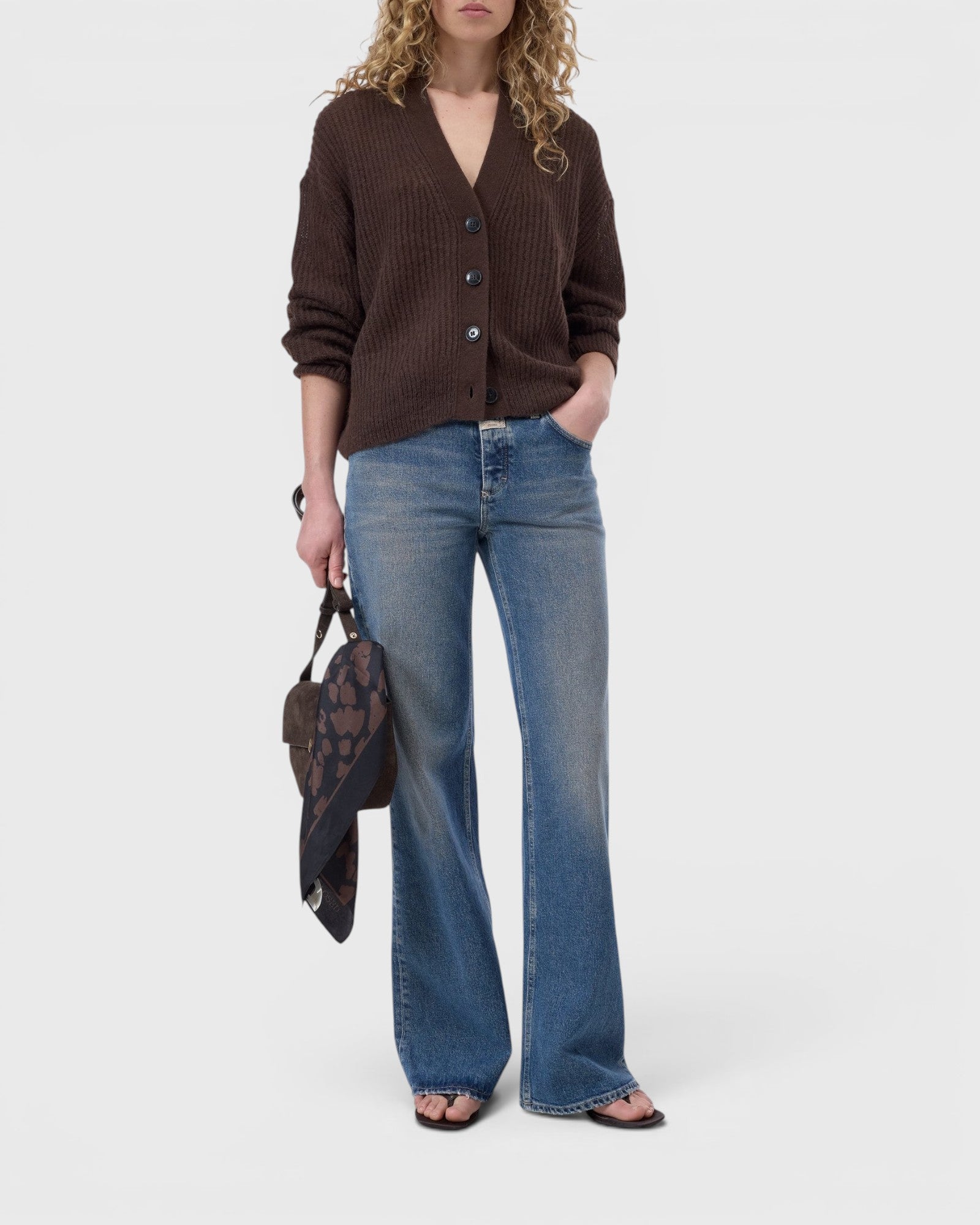 JONES + CO mahogany brown alpaca-blend V-neck cardigan with button closure, worn with blue jeans by a model.