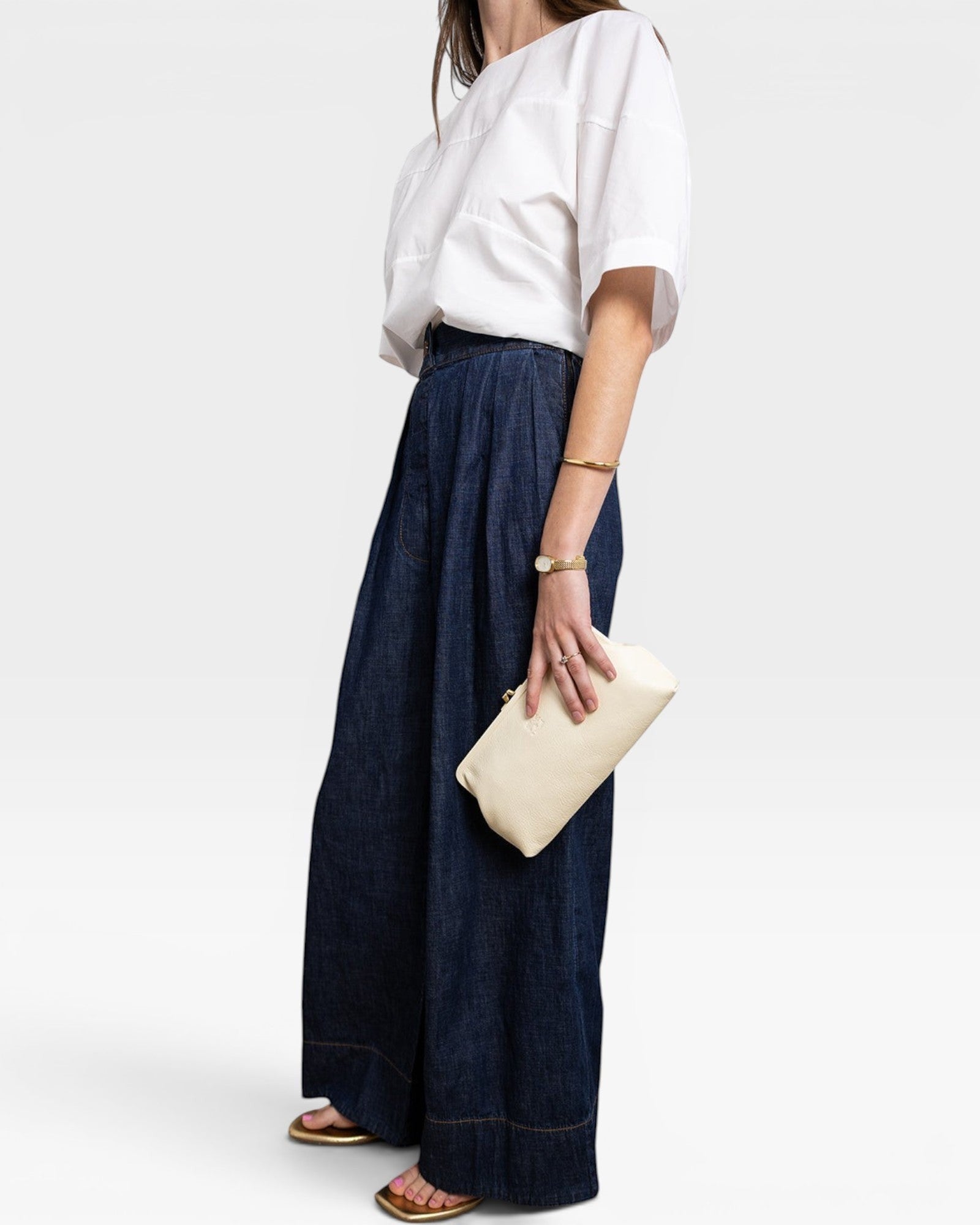 JONES + CO Manuela Classic Clutch in milk white pebbled leather with vintage clasp. Holds a phone and wallet.