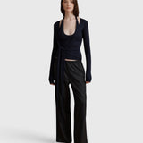 JONES + CO Margot wrap top in midnight knit with long sleeves and ballerina-inspired silhouette worn by a model