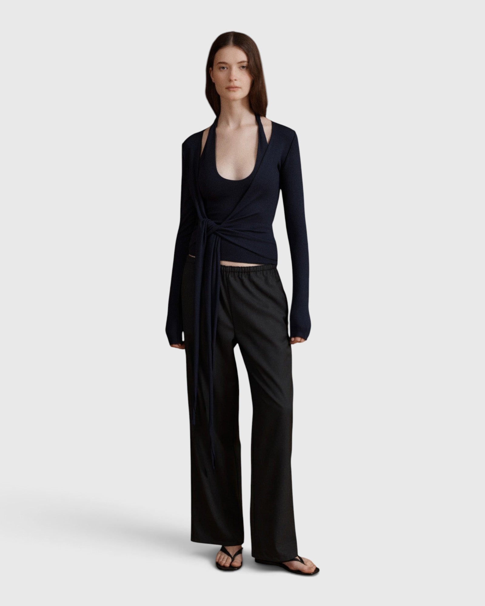 JONES + CO Margot wrap top in midnight knit with long sleeves and ballerina-inspired silhouette worn by a model