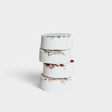 JONES + CO menthol eucalyptus shower steamer stack with dried botanical petals on a white background