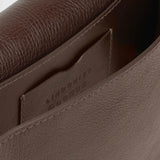 JONES + CO Mezzo crossbody bag in chaga brown textured leather with brass hardware and interior card pocket.