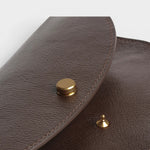JONES + CO Mezzo crossbody bag in Chaga brown leather with brass hardware and stitching detail.