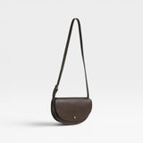 JONES + CO Mezzo crossbody bag in dark brown textured leather with brass hardware and adjustable strap.