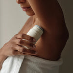 JONES + CO Microbiome Balancing Deodorant in a twist-up tube, applied to underarm. Aluminum-free formula.