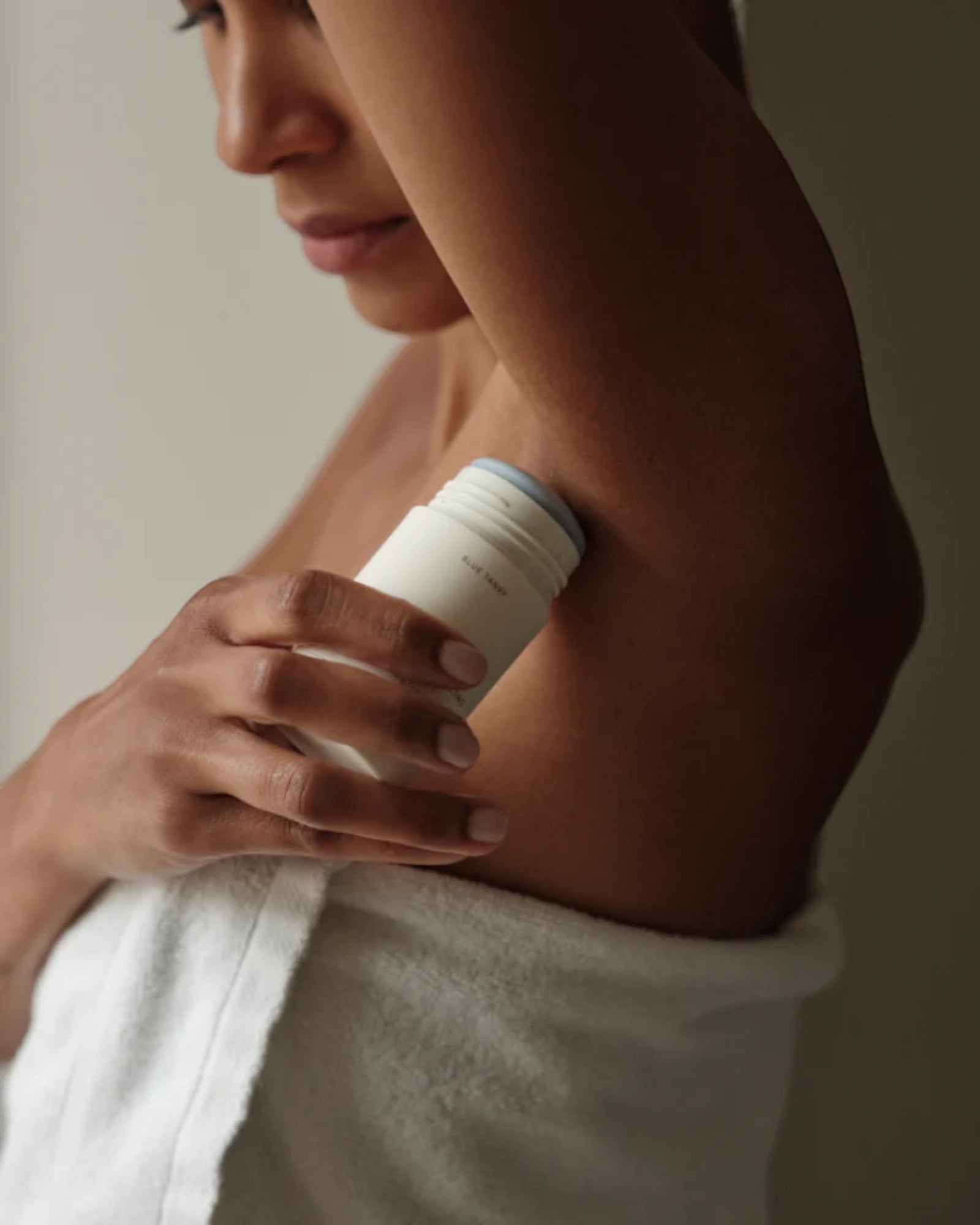 JONES + CO Microbiome Balancing Deodorant in a twist-up tube, applied to underarm. Aluminum-free formula.
