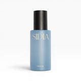 JONES + CO MIDAS Body Mist in a light blue bottle with a black cap, featuring gold lettering.