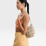 JONES + CO Mini Web Bag in silver, crafted from macrame leather beads. Sculptural yet slouchy shoulder bag.