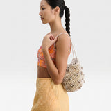 JONES + CO Mini Web Bag in silver, crafted from macrame leather beads. Sculptural yet slouchy shoulder bag.