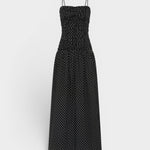 JONES + CO Mira maxi dress in black with off-white polka dots, featuring a ruched bodice and thin spaghetti straps.