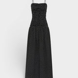 JONES + CO Mira maxi dress in black with off-white polka dots, featuring a ruched bodice and thin spaghetti straps.
