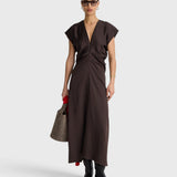 JONES + CO  apiece apart Monde black coffee bias-cut maxi dress with V-neck, front zip, and draped silhouette on a model.