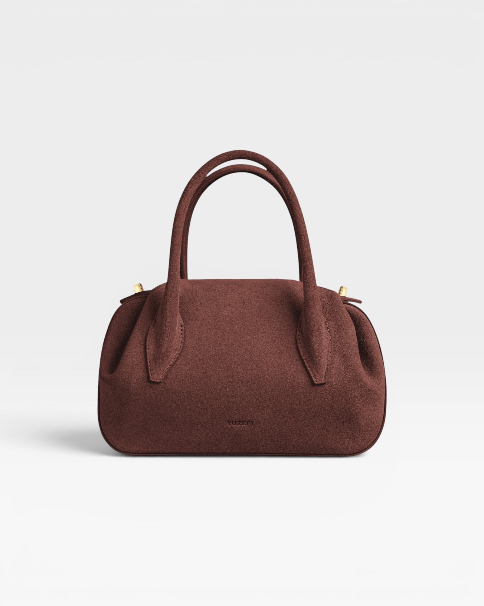 JONES + CO Muscat brown suede mini duffle bag with top handles and gold hardware details