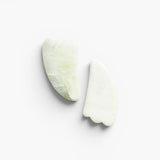 JONES + CO natural jade gua sha stones for depuffing and improving circulation. Light green and white marbled stone.