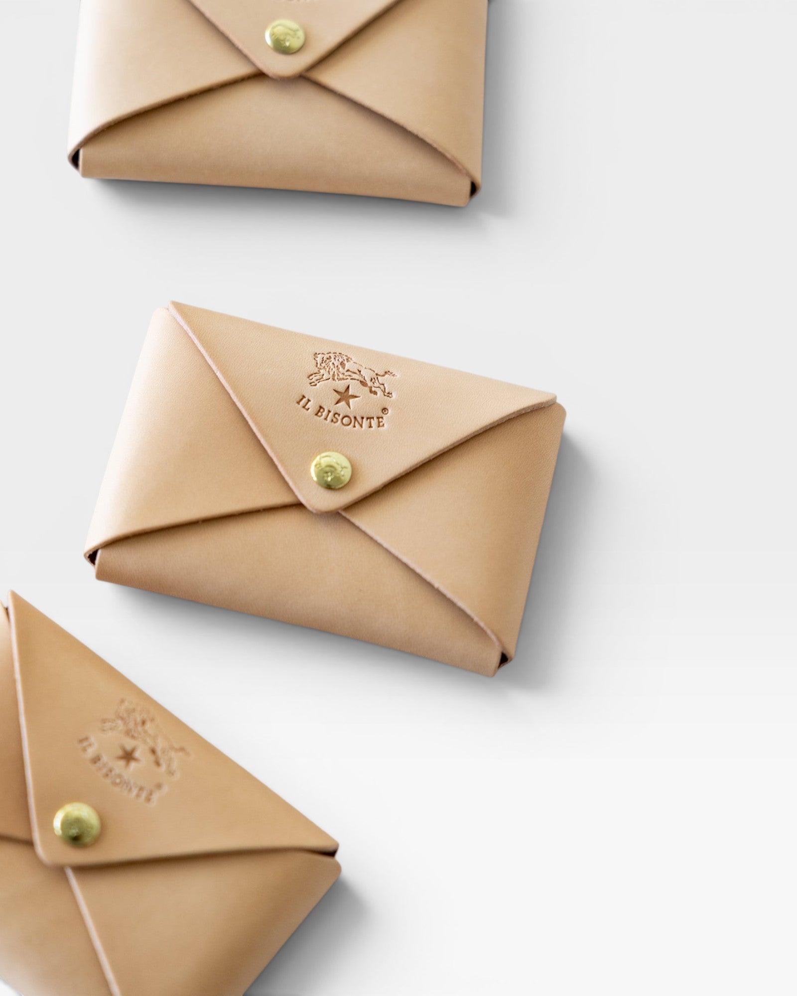 JONES + CO natural vegetable-tanned cowhide card case with brass snap closure and embossed logo.