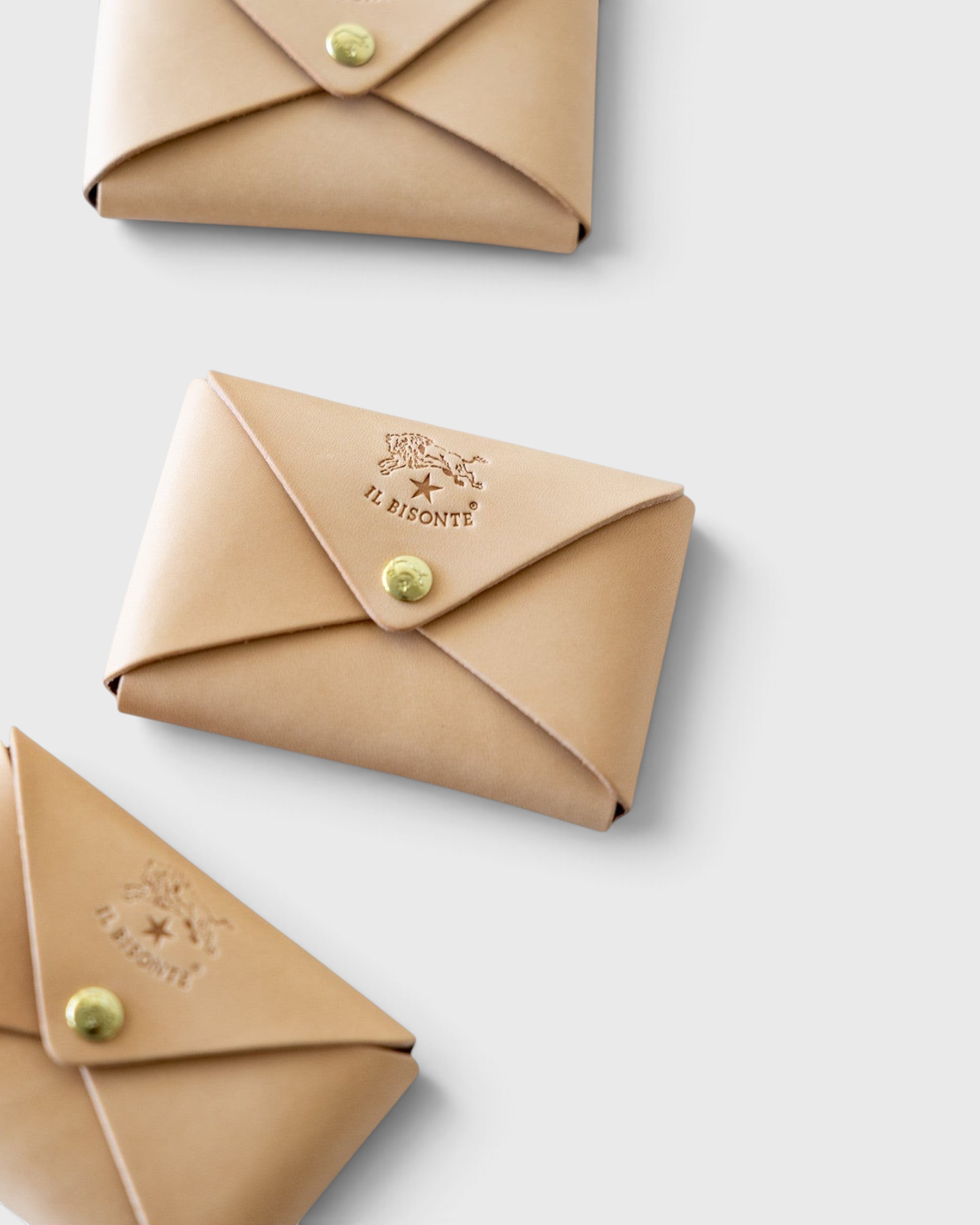JONES + CO natural vegetable-tanned cowhide card case with brass snap closure and embossed logo.