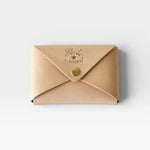 JONES + CO natural vegetable-tanned cowhide Sovana card case with envelope closure and brass snap button.