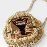 JONES + CO natural raffia crochet mini clutch with shell embellishments and gold satin lining. Features a chain strap.