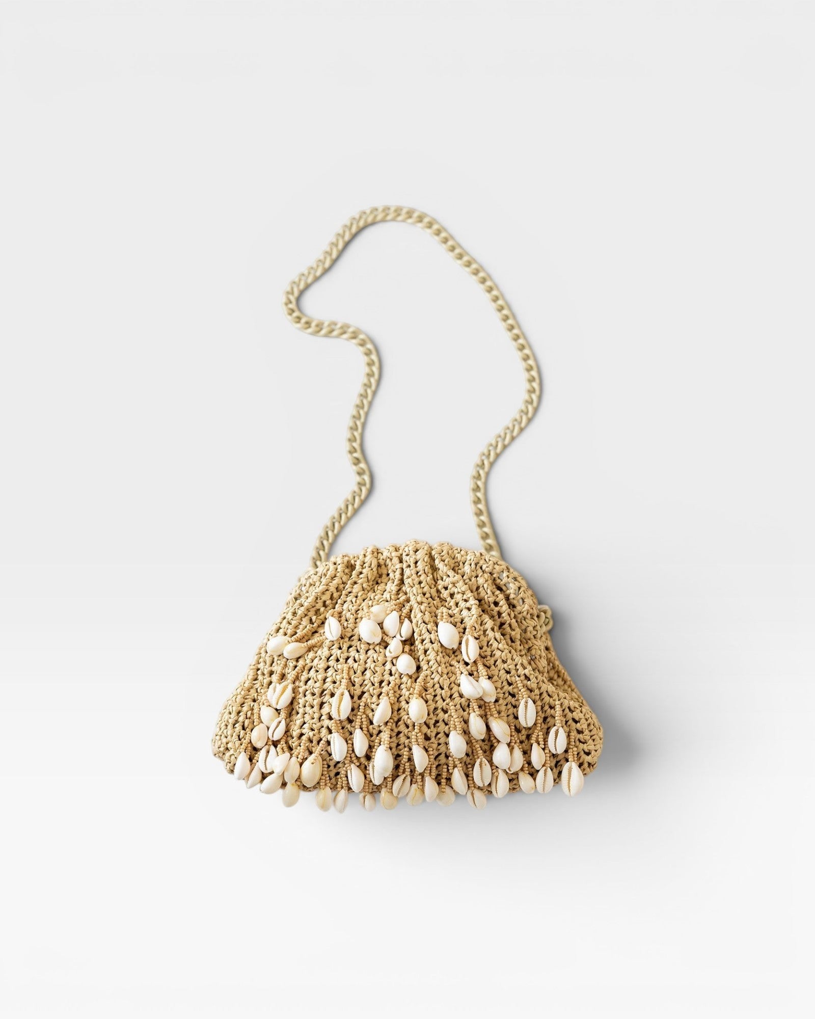 JONES + CO natural raffia crochet mini clutch bag with shell embellishments and gold chain strap.