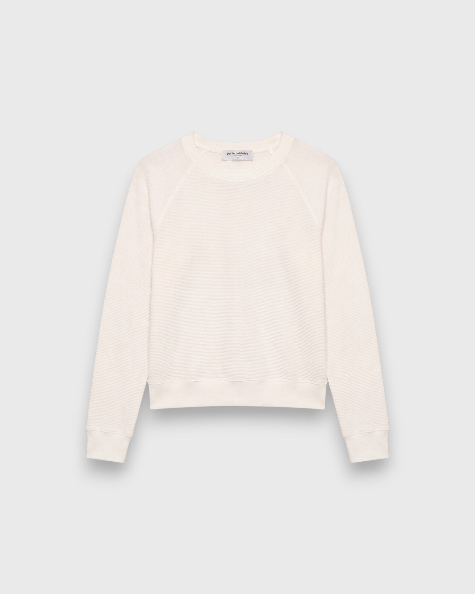 JONES + CO Jasper crew neck sweatshirt in natural textured jersey fabric with long sleeves and ribbed cuffs.