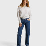 Model wearing JONES + CO Jasper textured jersey crew neck sweater in natural white with blue jeans