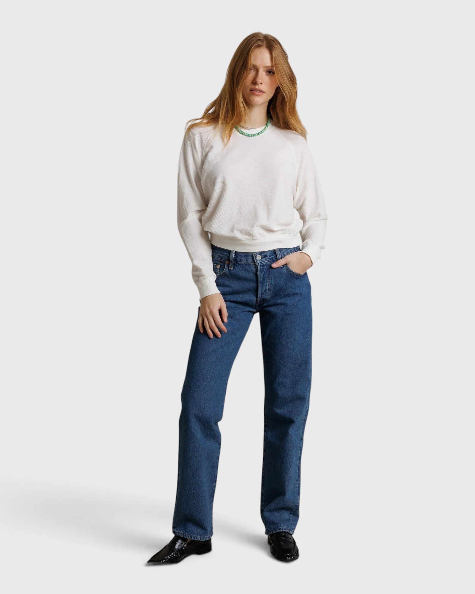 Model wearing JONES + CO Jasper textured jersey crew neck sweater in natural white with blue jeans