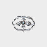 JONES + CO Vintage Navajo Thunderbird brooch in sterling silver with turquoise accent. Oval shape with detailed wings and feathers.