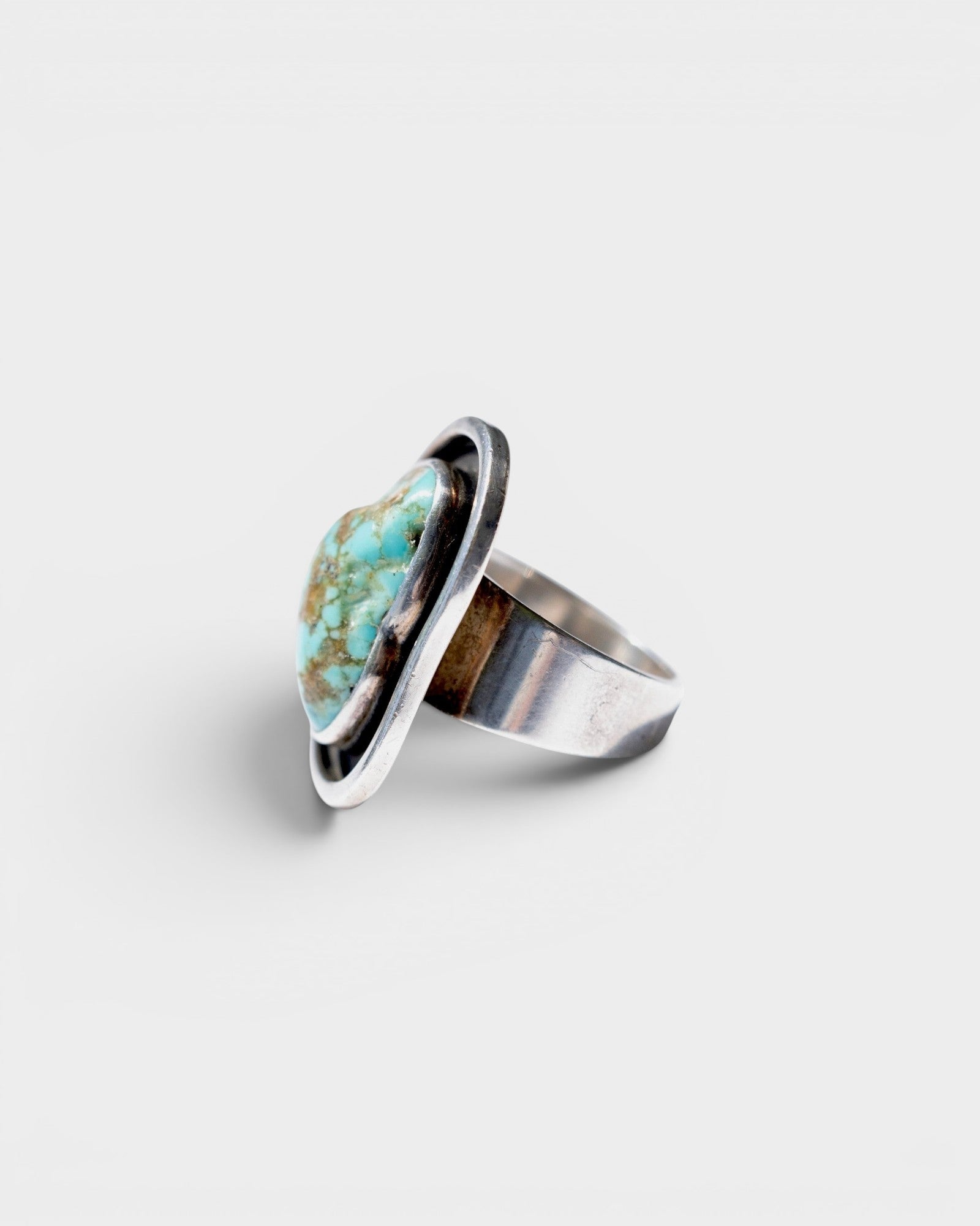 JONES + CO Vintage Navajo oval turquoise ring in sterling silver with unique matrix patterns.