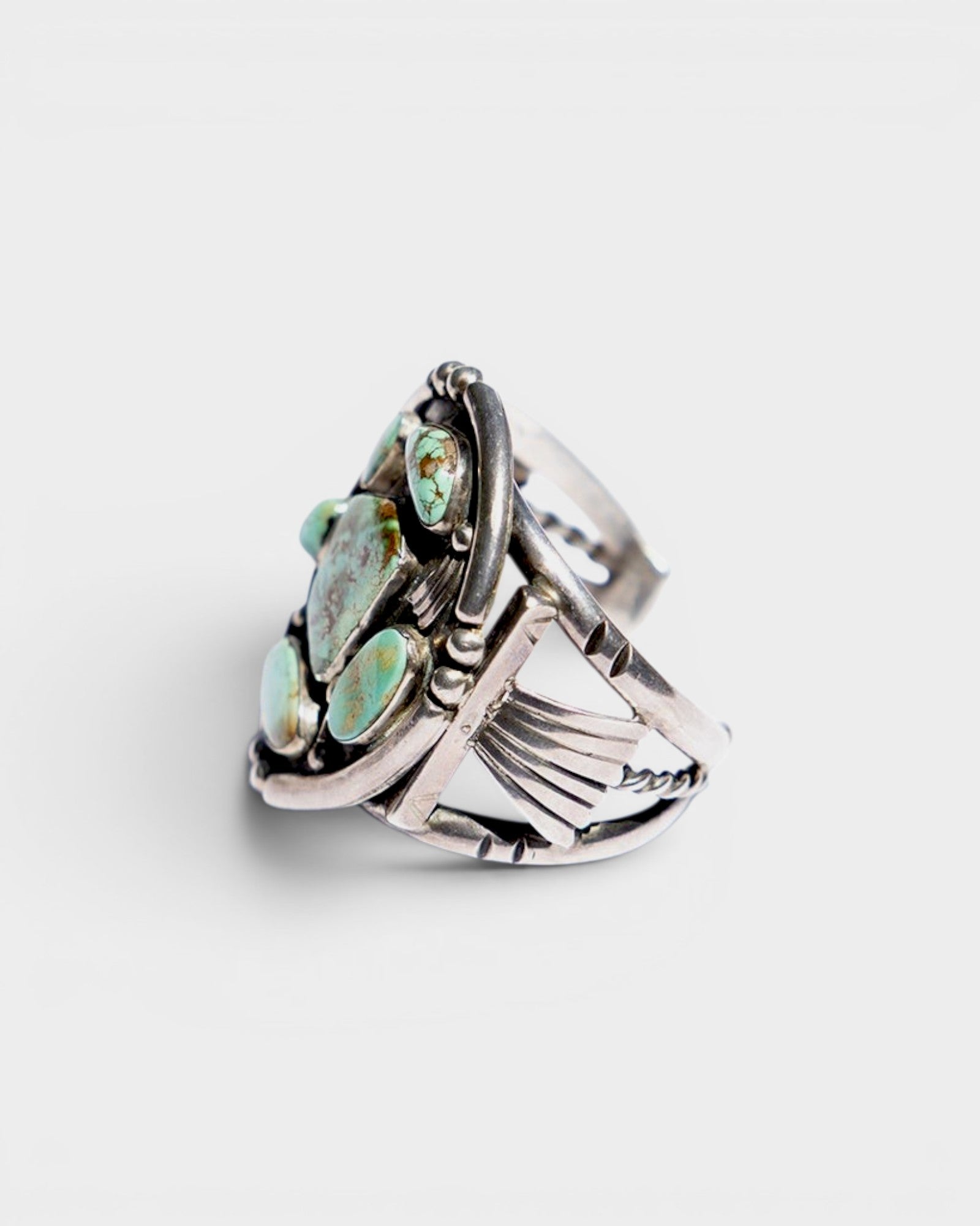 JONES + CO Navajo vintage sterling silver cuff bracelet with green turquoise stones and intricate detailing.