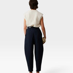 JONES + CO navy Brady trousers with a high-waisted, tapered leg and cropped hem, shown from the back on a model.