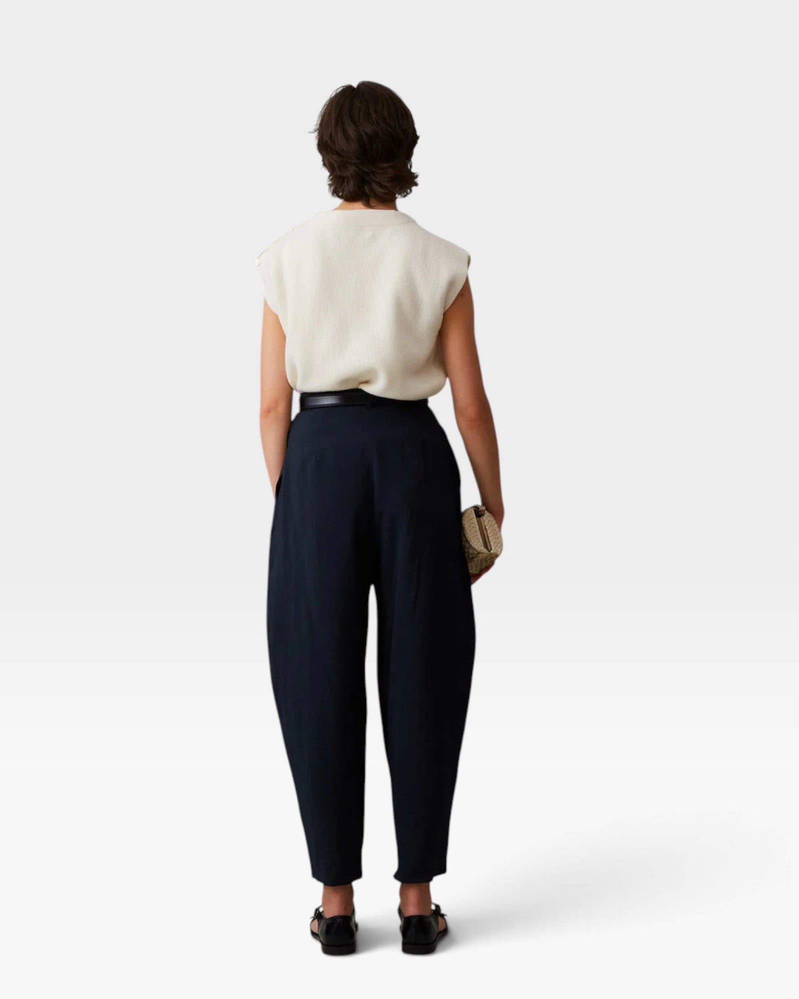 JONES + CO navy Brady trousers with a high-waisted, tapered leg and cropped hem, shown from the back on a model.