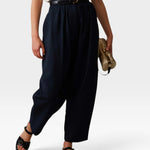 JONES + CO navy Brady trousers with a high-waisted gathered fit, tapered cropped leg, and belt loops.