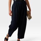 JONES + CO navy Brady trousers with a high-waisted gathered fit, tapered cropped leg, and belt loops.
