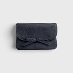 JONES + CO navy blue pebbled leather petite case with a decorative knotted bow and hidden magnetic closure