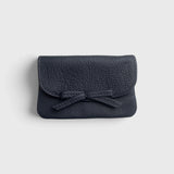 JONES + CO navy blue pebbled leather petite case with a decorative knotted bow and hidden magnetic closure