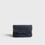 JONES + CO navy blue pebbled leather petite case with a decorative knotted bow and hidden magnetic closure